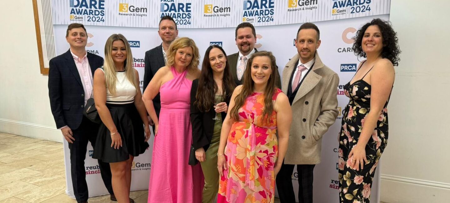 WPR team in front of a Dare Awards 2024 banner