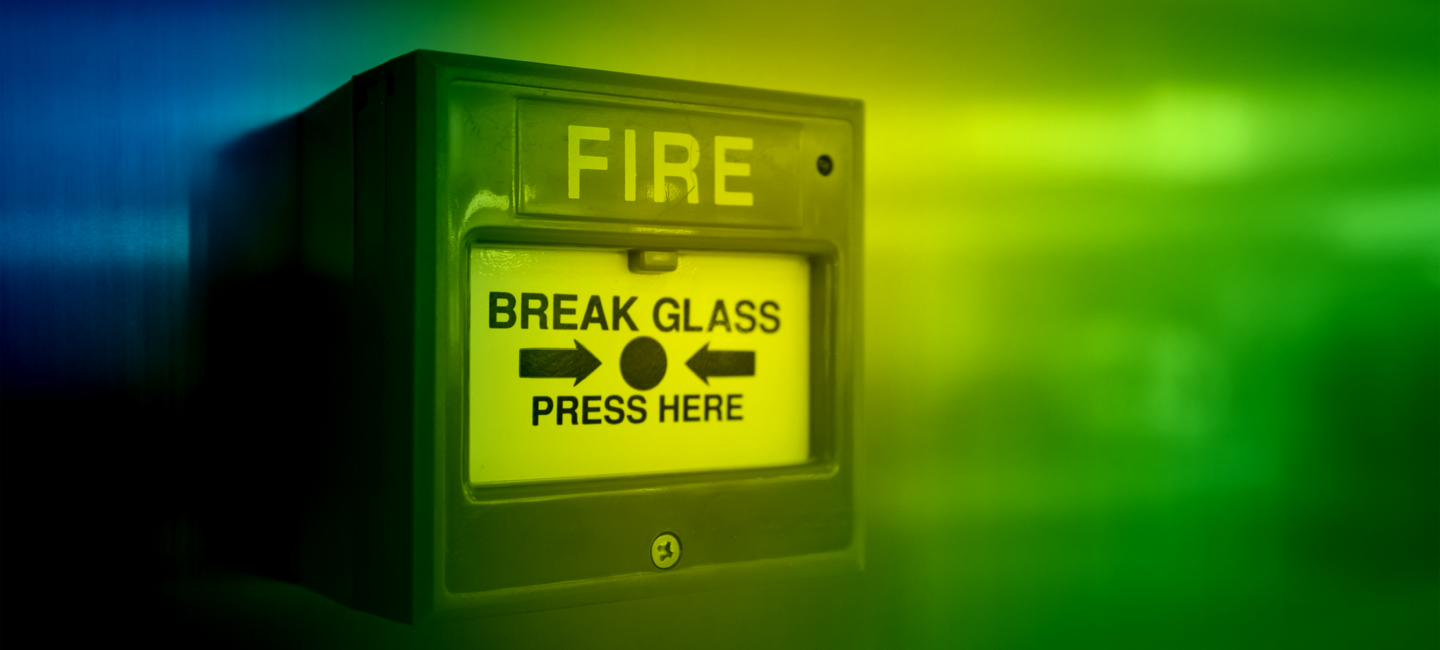 A break glass in case of emergency sign representing crisis communications